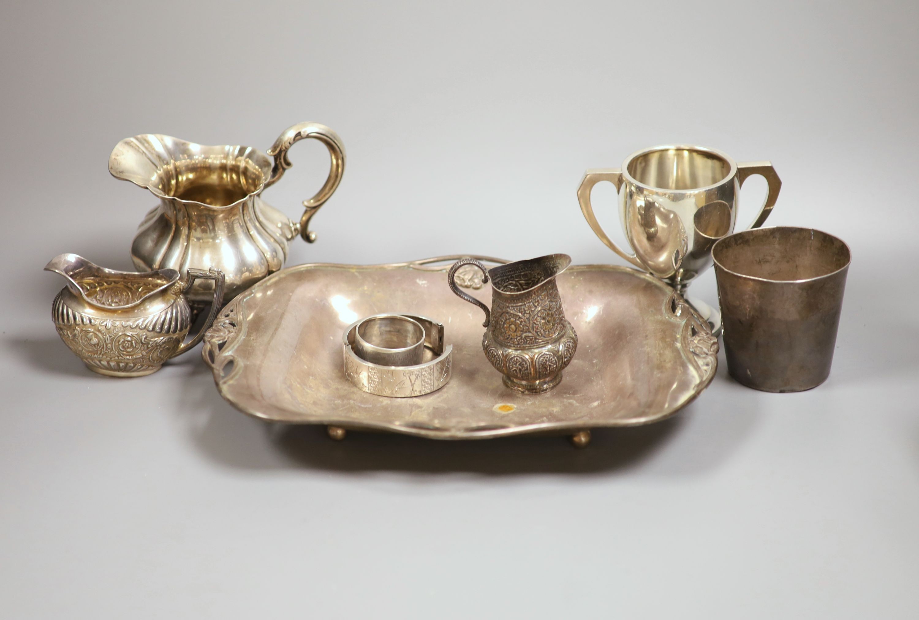 A silver dish, marks rubbed, a silver cream jug, similar 800 jug and five other items, weighable silver 28oz.